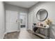 Bright foyer with wood-look tile flooring, neutral walls, and stylish decor at 12105 W Wier Ave, Avondale, AZ 85323