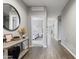 Long hallway with wood-look flooring, leading to bedrooms with neutral paint at 12105 W Wier Ave, Avondale, AZ 85323