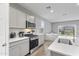 Modern kitchen with stainless steel appliances, white countertops, and ample cabinet space at 12105 W Wier Ave, Avondale, AZ 85323