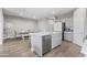 Spacious open-concept kitchen with an island, grey cabinets, and stainless steel appliances at 12105 W Wier Ave, Avondale, AZ 85323