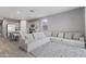 Spacious living area showcasing a comfortable sectional sofa and open-concept kitchen at 12105 W Wier Ave, Avondale, AZ 85323