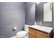 Stylish powder room with modern vanity, sleek fixtures, and patterned wallpaper at 12834 W Forest Pleasant Pl, Peoria, AZ 85383