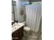 Bathroom featuring a vanity with dark wood cabinets, a mirror, and a white chevron shower curtain at 12834 W Forest Pleasant Pl, Peoria, AZ 85383