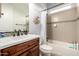 Neutral toned bathroom featuring a shower-tub combo, wood vanity, and a large mirror at 12834 W Forest Pleasant Pl, Peoria, AZ 85383