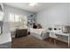 Well-lit bedroom with a bed, desk, and plantation shutters for a cozy and functional space at 12834 W Forest Pleasant Pl, Peoria, AZ 85383
