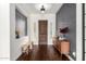 Elegant entryway with wood floors, complemented by a wooden console table and a dark accent wall, creating a welcoming ambiance at 12834 W Forest Pleasant Pl, Peoria, AZ 85383