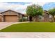 Charming single-story home with a well-manicured front yard, complemented by desert landscaping and a neutral color scheme at 12834 W Forest Pleasant Pl, Peoria, AZ 85383