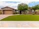 Charming single-story home with a well-manicured front yard, complemented by desert landscaping and a neutral color scheme at 12834 W Forest Pleasant Pl, Peoria, AZ 85383