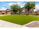 Charming single-story home with a well-manicured front yard, complemented by desert landscaping and a neutral color scheme at 12834 W Forest Pleasant Pl, Peoria, AZ 85383