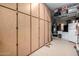 Well-organized garage with built-in storage cabinets, a refrigerator, and epoxy flooring at 12834 W Forest Pleasant Pl, Peoria, AZ 85383