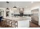 Bright kitchen with an oversized island, granite countertops, stainless appliances, and white cabinetry at 12834 W Forest Pleasant Pl, Peoria, AZ 85383