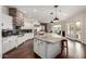 Spacious kitchen with large island, granite counters, stainless appliances, and brick accents at 12834 W Forest Pleasant Pl, Peoria, AZ 85383