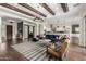 Expansive open concept living room with hardwood floors, exposed beams, and comfortable seating at 12834 W Forest Pleasant Pl, Peoria, AZ 85383