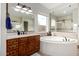 Charming bathroom featuring dual vanity, a large window, a tub and a walk-in shower at 12834 W Forest Pleasant Pl, Peoria, AZ 85383