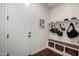 Mudroom featuring a bench with storage baskets, hooks with bags and hats, and a white paneled wall at 12834 W Forest Pleasant Pl, Peoria, AZ 85383