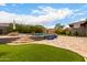 Backyard pool boasts travertine tile patio, lush landscaping, and a relaxing outdoor space at 12834 W Forest Pleasant Pl, Peoria, AZ 85383