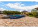 A freeform pool features a raised beam with a tiled waterfall, creating a luxurious outdoor oasis at 12834 W Forest Pleasant Pl, Peoria, AZ 85383