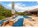 Relaxing pool with loungers and umbrella offers a perfect retreat for relaxation and outdoor enjoyment at 12834 W Forest Pleasant Pl, Peoria, AZ 85383