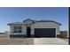 Charming single-story home featuring a gray two-car garage and modern architectural details against a clear blue sky at 1300 W Bealey Ave, Coolidge, AZ 85128