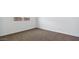 Bedroom featuring carpeted floors, white walls, and a window at 1337 W Hess Ave, Coolidge, AZ 85128