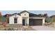 New construction home with a two car garage, stucco, and desert landscaping in front at 1337 W Hess Ave, Coolidge, AZ 85128