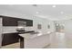 Spacious kitchen with stainless steel appliances, dark wood cabinets, and a marble island at 1337 W Hess Ave, Coolidge, AZ 85128