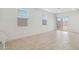 Living room featuring tiled floors, white walls, large windows and sliding glass doors at 1337 W Hess Ave, Coolidge, AZ 85128
