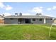 Expansive backyard with lush lawn, covered patio, and mature trees at 1408 N 62Nd Pl, Mesa, AZ 85205