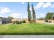 Expansive backyard with lush lawn, mature trees, and charming garden structure at 1408 N 62Nd Pl, Mesa, AZ 85205