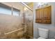 Beautiful bathroom featuring a tiled shower with glass door and window bringing in natural light at 1408 N 62Nd Pl, Mesa, AZ 85205