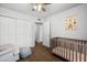Cozy bedroom featuring neutral decor, a ceiling fan, and easy access to nearby rooms at 1408 N 62Nd Pl, Mesa, AZ 85205