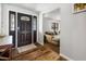 Welcoming entryway with hardwood flooring, decorative front door and view into the living area at 1408 N 62Nd Pl, Mesa, AZ 85205