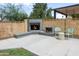 Outdoor fireplace with stacked brick, cozy seating, and landscaped yard at 1408 N 62Nd Pl, Mesa, AZ 85205