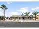 Charming single-story home featuring desert landscaping and mature palm trees at 1408 N 62Nd Pl, Mesa, AZ 85205