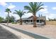 Attractive single-story home enhanced by well-maintained landscaping and stately palm trees at 1408 N 62Nd Pl, Mesa, AZ 85205