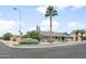 Corner view of gray house with tropical landscaping, desert plants and trimmed bushes at 1408 N 62Nd Pl, Mesa, AZ 85205
