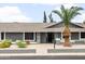 Home exterior featuring a front walkway and gray facade complemented by desert landscaping at 1408 N 62Nd Pl, Mesa, AZ 85205