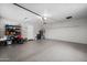 Spacious garage with epoxy flooring, utility shelving, and modern water heater at 1408 N 62Nd Pl, Mesa, AZ 85205