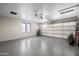 Clean garage features epoxy flooring, decorative garage door, and utility shelving at 1408 N 62Nd Pl, Mesa, AZ 85205