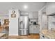 The kitchen features stainless steel refrigerator and updated countertops at 1408 N 62Nd Pl, Mesa, AZ 85205
