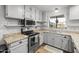 This kitchen has granite countertops, stainless steel appliances, and updated cabinets at 1408 N 62Nd Pl, Mesa, AZ 85205