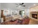 Bright and spacious living room featuring a fireplace and seamless flow to the kitchen and dining area at 1408 N 62Nd Pl, Mesa, AZ 85205