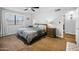 Spacious bedroom featuring a ceiling fan, neutral walls and ensuite bathroom at 1408 N 62Nd Pl, Mesa, AZ 85205