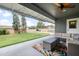 Inviting covered patio with outdoor seating, fireplace, and view of landscaped backyard at 1408 N 62Nd Pl, Mesa, AZ 85205