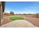 Manicured backyard featuring a central artificial lawn, gravel, and string lights at 16039 W Pima St, Goodyear, AZ 85338