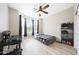 Bright bedroom featuring light-colored hardwood floors, a ceiling fan, and a bay window at 16039 W Pima St, Goodyear, AZ 85338