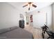 Cozy bedroom featuring hardwood floors, a ceiling fan, and a closet with sliding doors at 16039 W Pima St, Goodyear, AZ 85338