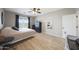 Bedroom with natural light, ceiling fan, wood floors, and dark wood furniture at 16039 W Pima St, Goodyear, AZ 85338
