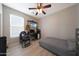 Well-lit bedroom with hardwood floors, a ceiling fan, and a mounted television at 16039 W Pima St, Goodyear, AZ 85338