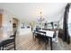 Open concept dining area with hardwood floors and view into the living room at 16039 W Pima St, Goodyear, AZ 85338